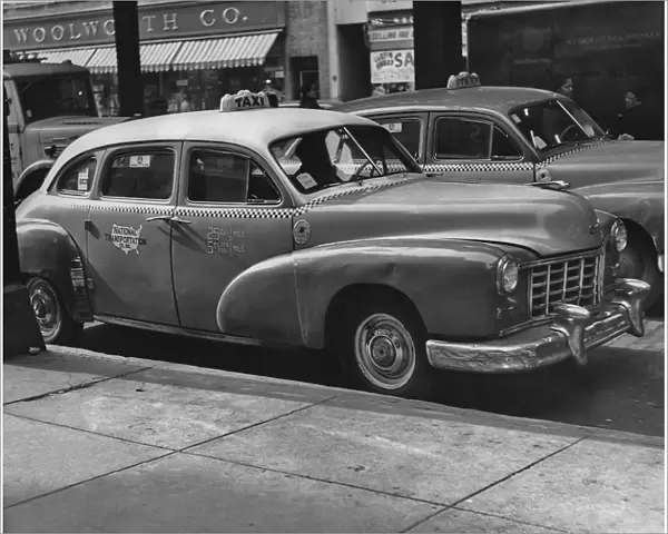 Taxi Cab. A taxi cab in the streets of New York City in the 1950 s