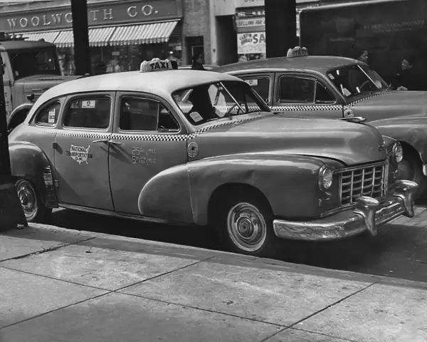 Taxi Cab. A taxi cab in the streets of New York City in the 1950 s