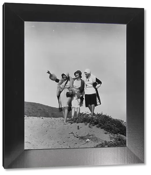 Flappers. circa 1928: A group of flappers on a beach