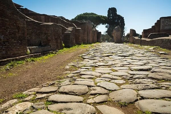 An ancient Roman road in the ruins of the Ancient Roman harbour city of Ostia Antica in Rome, Italy
