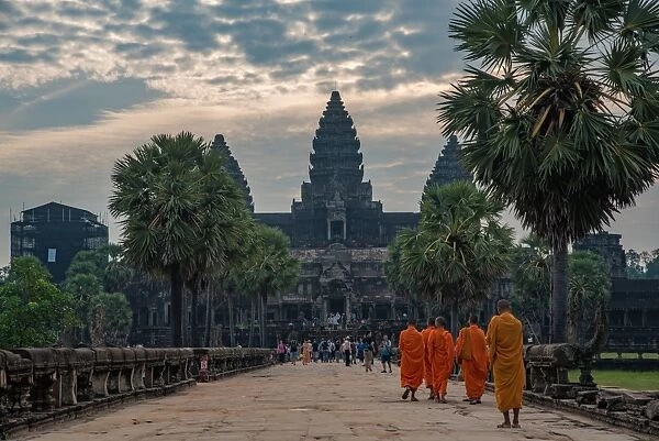 Angkor Wat with monk. Famous landmark, place of worship and popular tourist travel destination in Asia