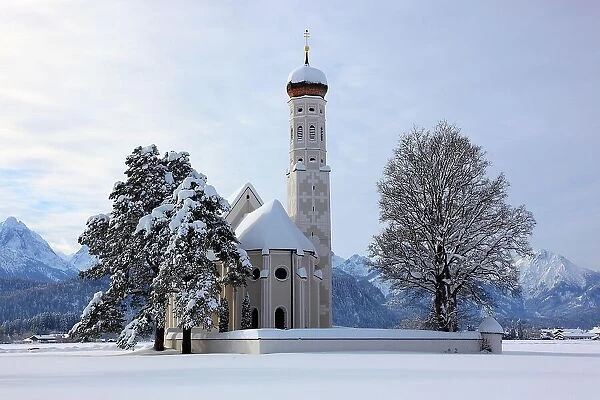 The baroque Coloman Church, St. Coloman, in winter in a landscape covered in deep snow, near Schwangau, Oestallgaeu, Swabia, Bavaria, Germany