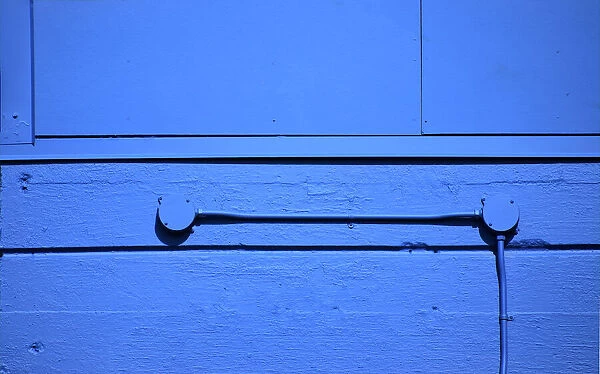 Blue Wall. A color photograph of the wall to the concrete wall to a commercial