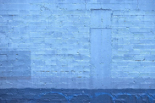 Blue Wall. A color photograph of the wall to an aging commercial building