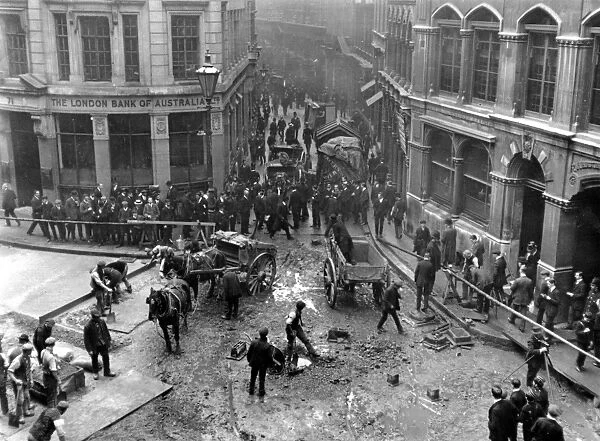 Clean Up. 2nd October 1912: Labourers at work clearing up debris after