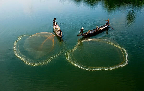 Fishermen go fishing on two boats in Hue, Vietnam