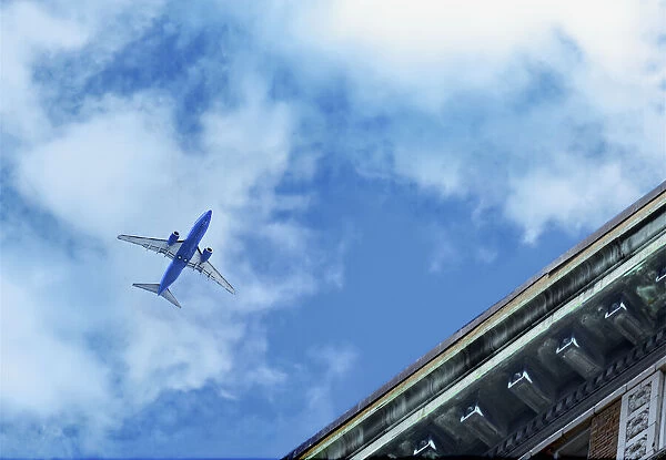 Flyover. A commercial jetliner flies over an aging commercial building in Downtown Seattle