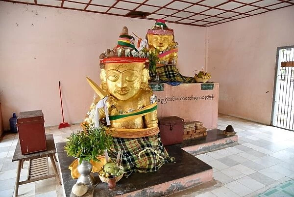 Two gold statues Shwe zi gon paya Temple, Bagan, unesco ruins Myanmar. Asia