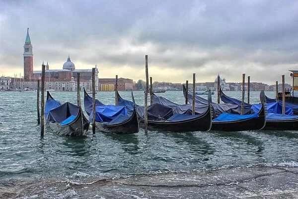Gondolas on flooded waterfront, Venice