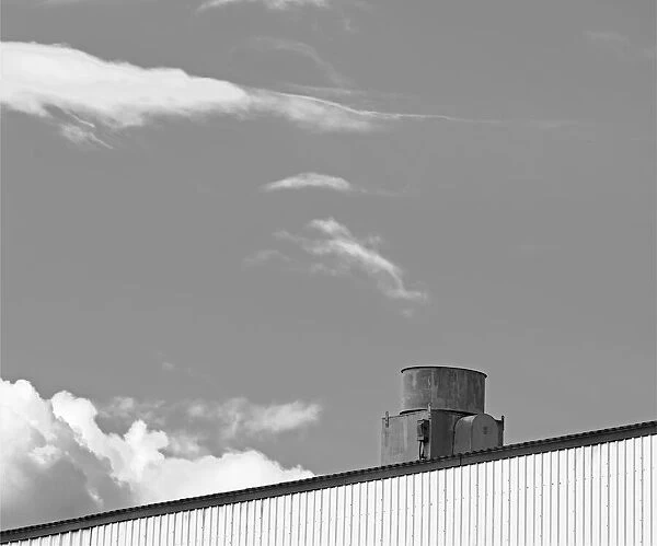 Gray Vent. A black and white photograph of the roof of a metal sided commercial