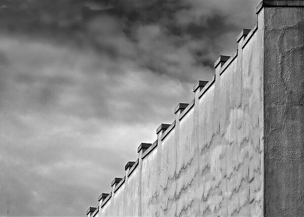 Gray Wall. A black and white photograph of the surrounding wall to a commercial