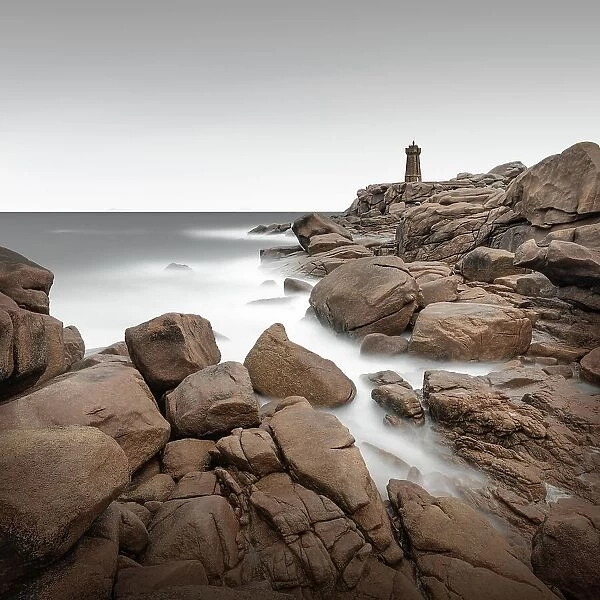 Long exposure of the Phare de Ploumanach lighthouse on the rugged coast of Brittany, France