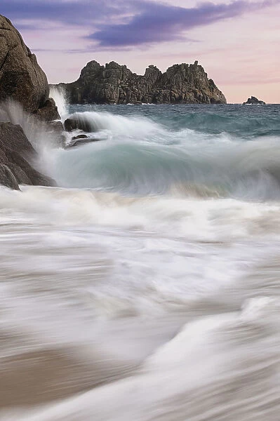Seascape. Waves crashing on rocks in Porthcurno beach at Cornwall