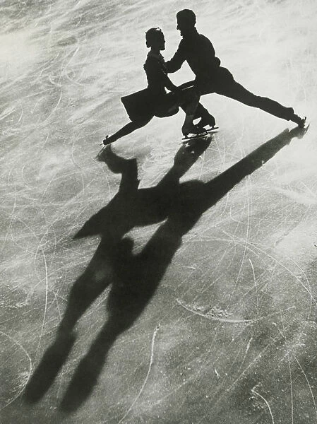 Silhouette of couple ice skating