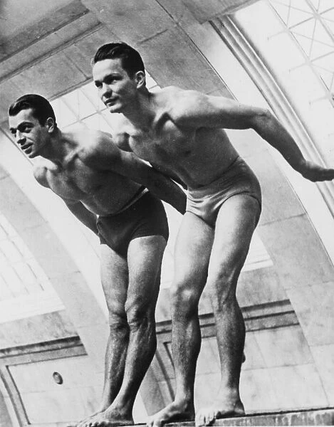 Swimming. circa 1926: Two men about to dive in for a swim
