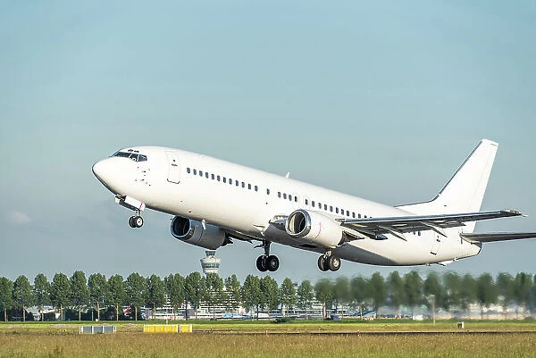 A white Boeing 737 airplane taking off