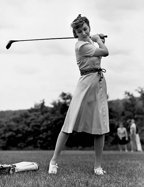 Woman golfing
