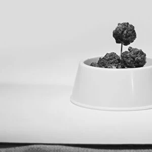 Bowl of meatballs against white background, close-up