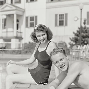 Couple sitting by pool. (Photo by H. Armstrong Roberts / Retrofile / Getty Images)