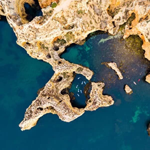 Drone view of stand up paddlers among rocks, Portugal
