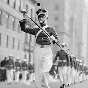 Drum major leading parade in old-fashioned uniforms, (B&W)