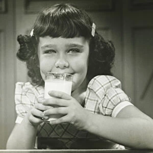 Girl (6-7) sitting at table, drinking milk, (B&W), (Close-up), (Portrait)