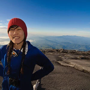 Japanese girl poses Mt Kinabalu, World Heritage