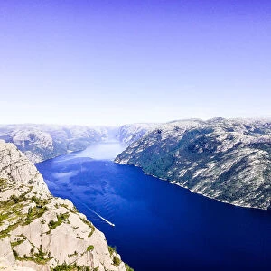 Lysefjord or Lysefjorden is a fjord located in the Ryfylke area in southwestern Norway. View of the fjord from the huge Preikestolen cliff, which is a major tourist destination for the region. Nature background. Image with copy space