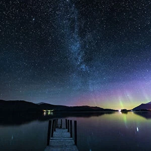 The Milky Way and Aurora Borealis from a jetty over Derwent water. English Lake District. UK