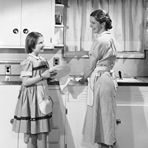 Mother and daughter doing dishes