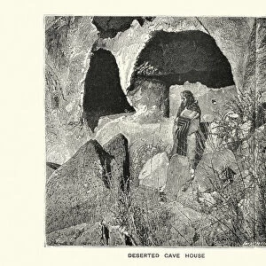 Native American woman outside a deserted cave dwelling