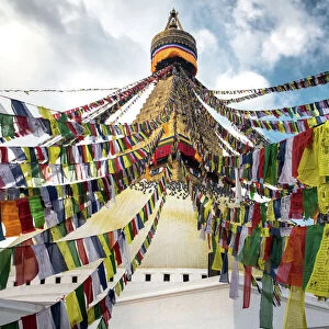 Prayer flags with the Boudhanath Stupa in Kathmandu, Nepal