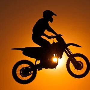 Silhouette of motocross at sunset