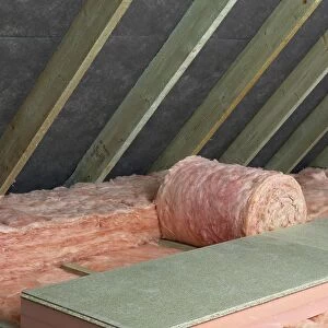 Storage decking on top of fiberglass roof insulating material in attic