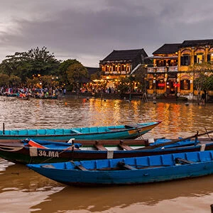 Traditional boats in front of ancient architecture in Hoi An, Vietnam