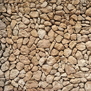 Typical Balearic dry stone wall made of yellow and red boulders