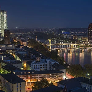 View of the city and the Main river from the top of the cathedral, of the new illuminated skyscraper of the European Central Bank, Flosserbrucke bridge and Ignatz Bubis Brucke bridge, at dusk, blue hour, city centre, Frankfurt am Main, Hesse, Germany
