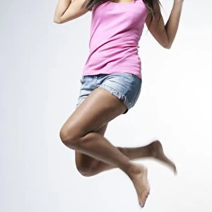 Young woman jumping for joy in the air