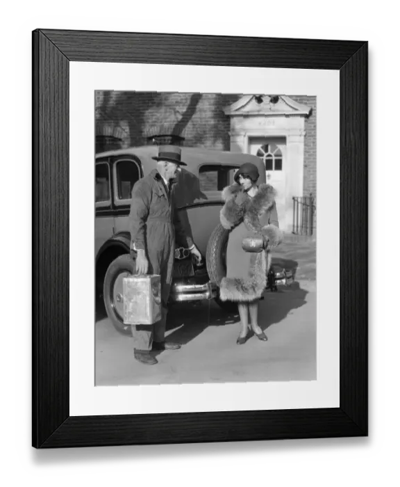 Framed Print : Couple. The Man Is Wearing A Fedora & Coveralls With 1 Hand On The Gas Tank Lid Of A Sedan & The Other Holding A Can The Woman A Cloche & A Fur Trim Coat Framed Print : Couple. The Man Is Wearing A Fedora & Coveralls With 1 Hand On The Gas Tank Lid Of A Sedan & The Other Holding A Can The Woman A Cloche & A Fur Trim Coat