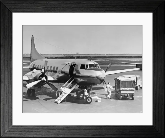 Framed Print : Man unloading cargo from plane Framed Print : Man unloading cargo from plane