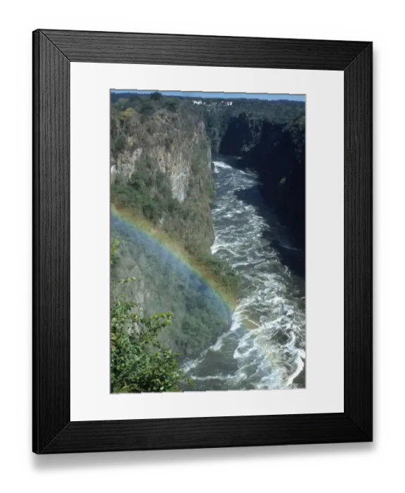 Framed Print : Circa 1955, A rainbow arcs over the gorge of Victoria Falls on the Zambezi River Framed Print : Circa 1955, A rainbow arcs over the gorge of Victoria Falls on the Zambezi River