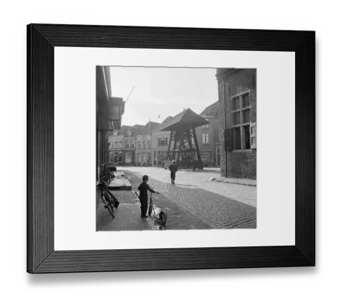 Framed Print : A child of the Haanapel family holds his scooter and watches the street in the town of Doesburg Framed Print : A child of the Haanapel family holds his scooter and watches the street in the town of Doesburg
