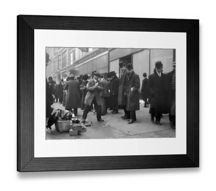 Framed Print : A crowd on a sidewalk observes street peddlers selling toys Framed Print : A crowd on a sidewalk observes street peddlers selling toys