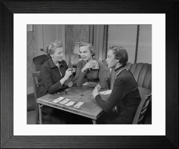 Framed Print : Three women playing cards in living room Framed Print : Three women playing cards in living room
