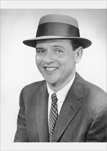 Man wearing hat, posing in studio, (B&W), portrait