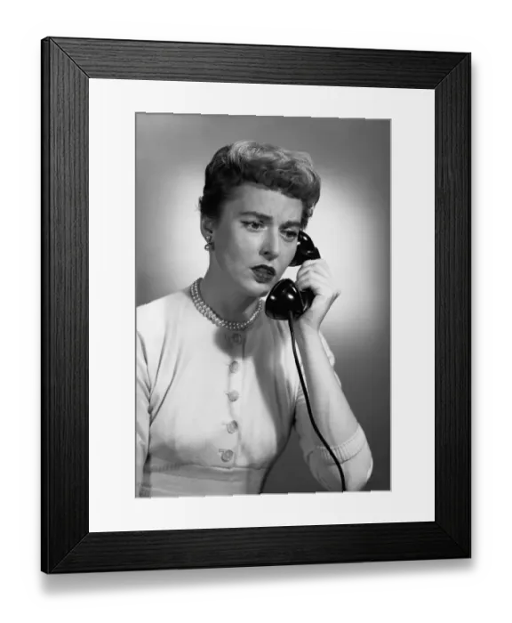 Framed Print : Woman talking on phone in studio, (B&W) Framed Print : Woman talking on phone in studio, (B&W)