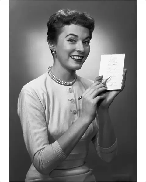 Woman note pad posing in studio, (B&W), portrait