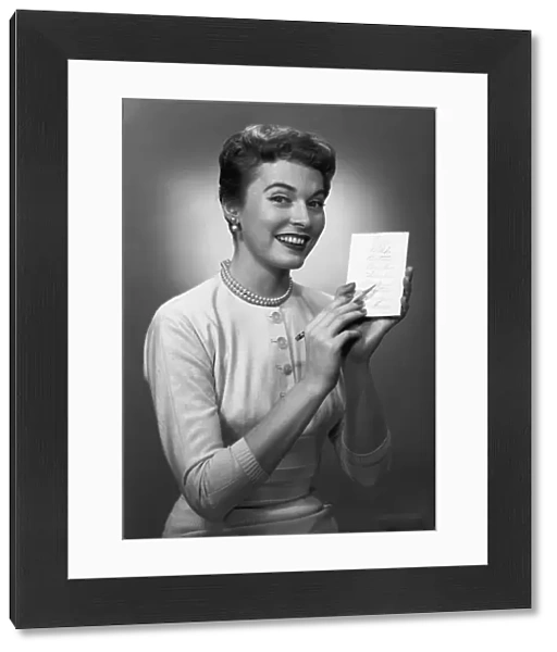 Woman note pad posing in studio, (B&W), portrait