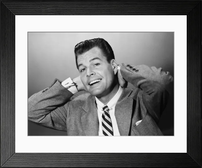 Framed Print : Smiling man stretching in studio, (B&W), portrait