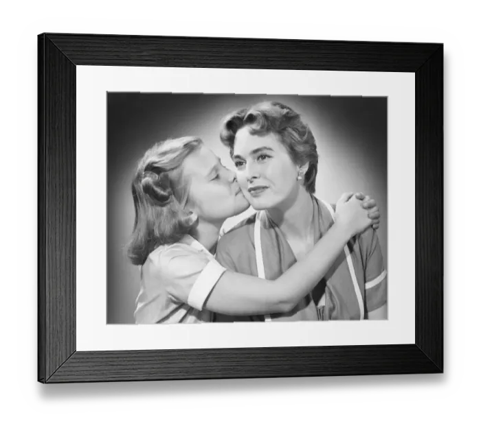 Framed Print : Girl (8-9) kissing mother, (B&W) Framed Print : Girl (8-9) kissing mother, (B&W)